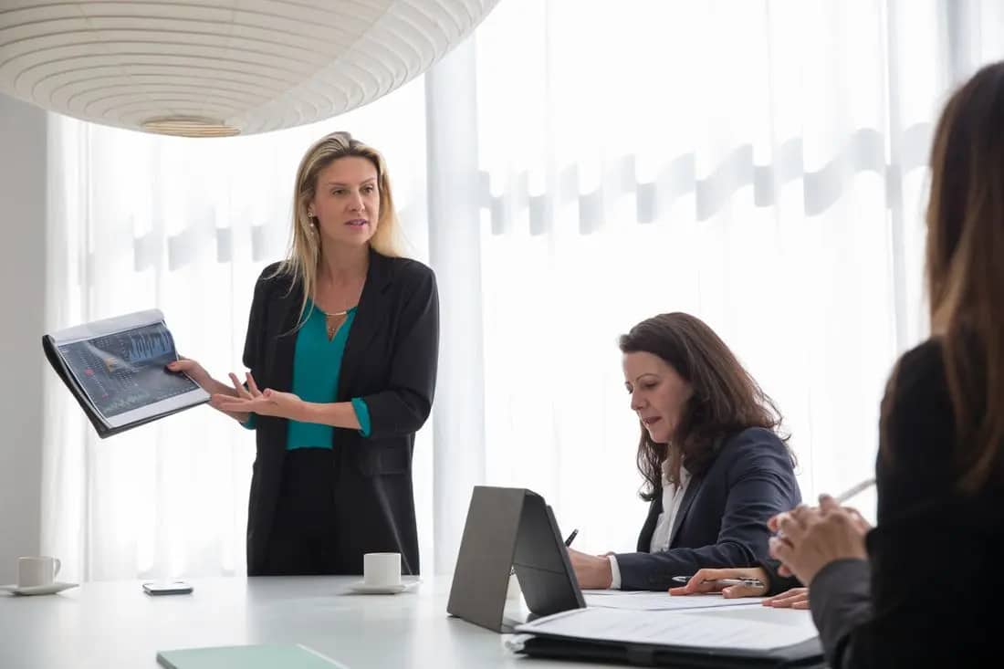 A consultant presenting to a team in a meeting room