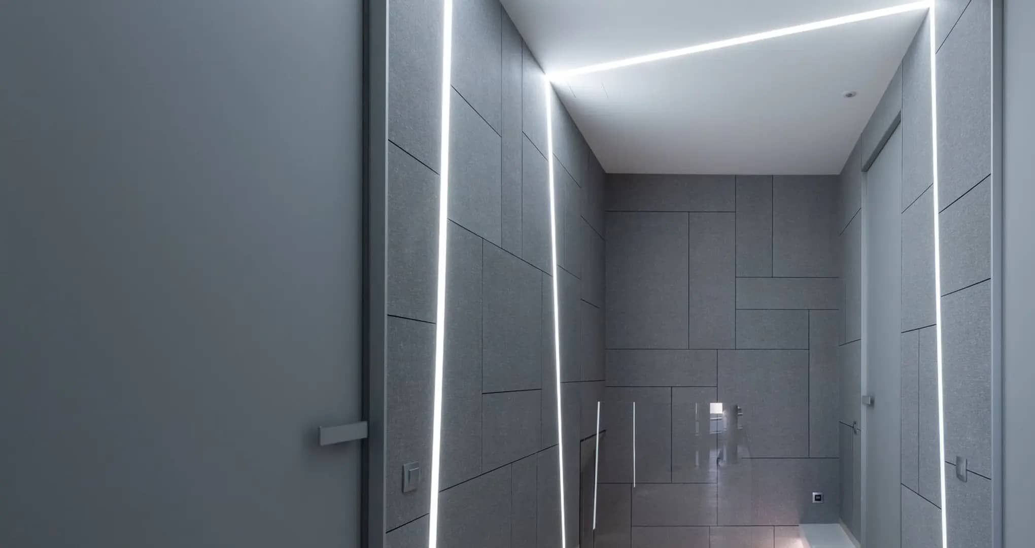 Modern office corridor lit with light strips